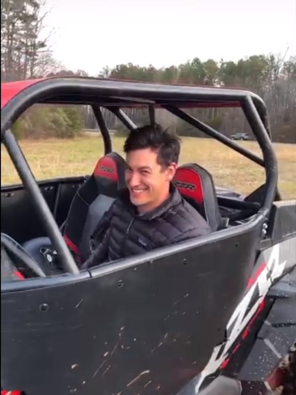 Joey Logano in a Polaris RZR XP 1000 showing off his Joey Logano new hair 
